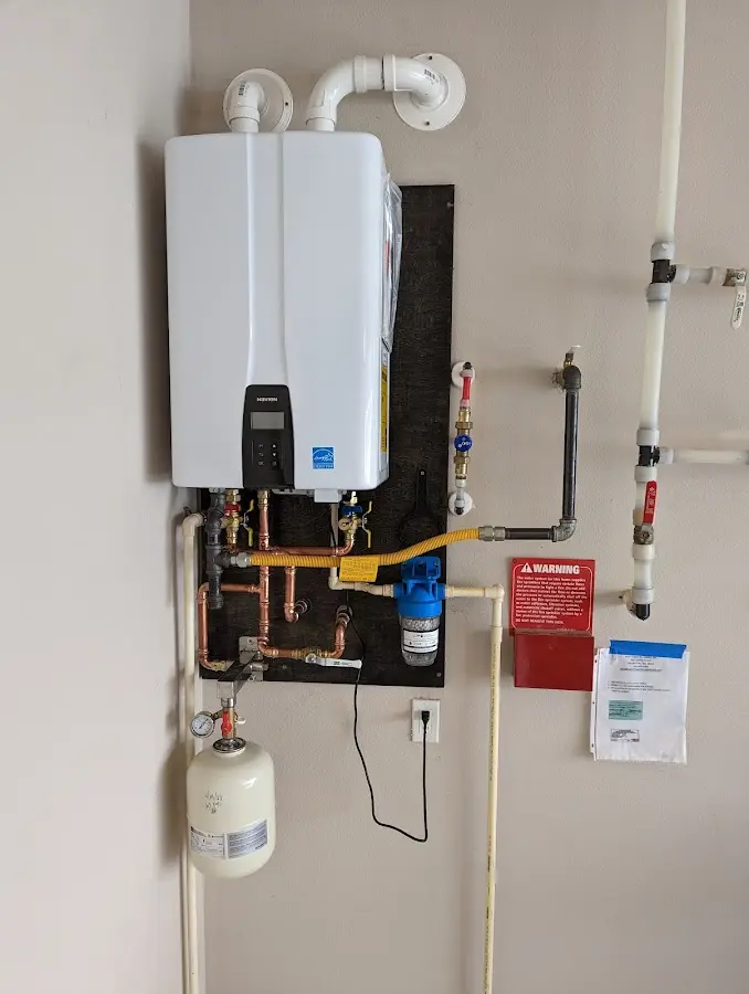 Professional plumber installing copper piping in a North Madison home